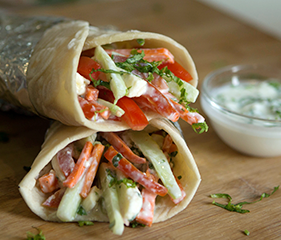 Healthy breakfast wrap with vegetables and creamy dressing