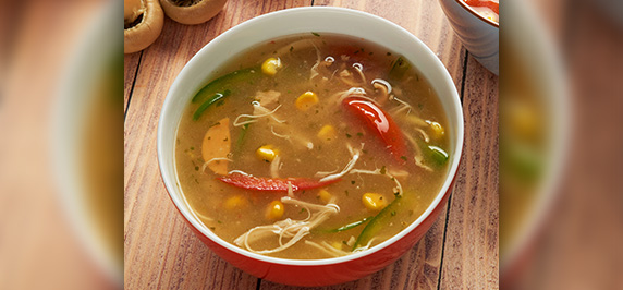 Corn soup with coconut milk chicken and vegetables in bowl