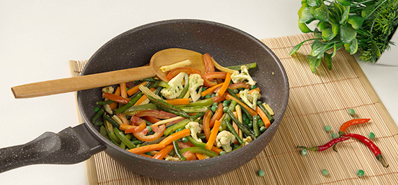 Mixed sautéed vegetables with carrots beans and capsicum in pan