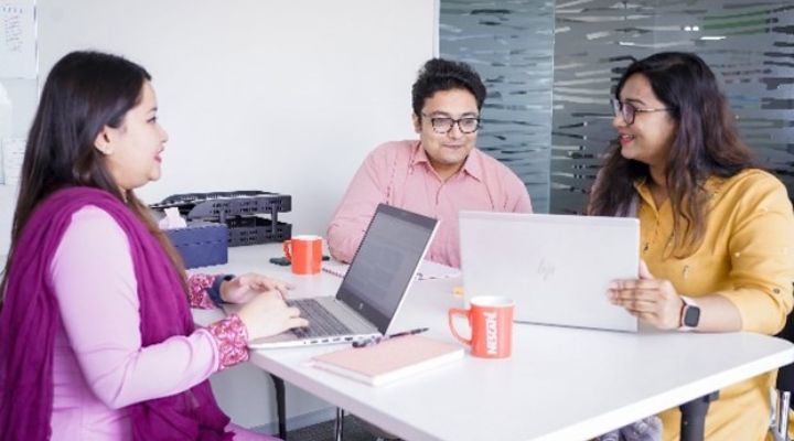 Team of diverse colleagues collaborating on product innovation in a modern office environment